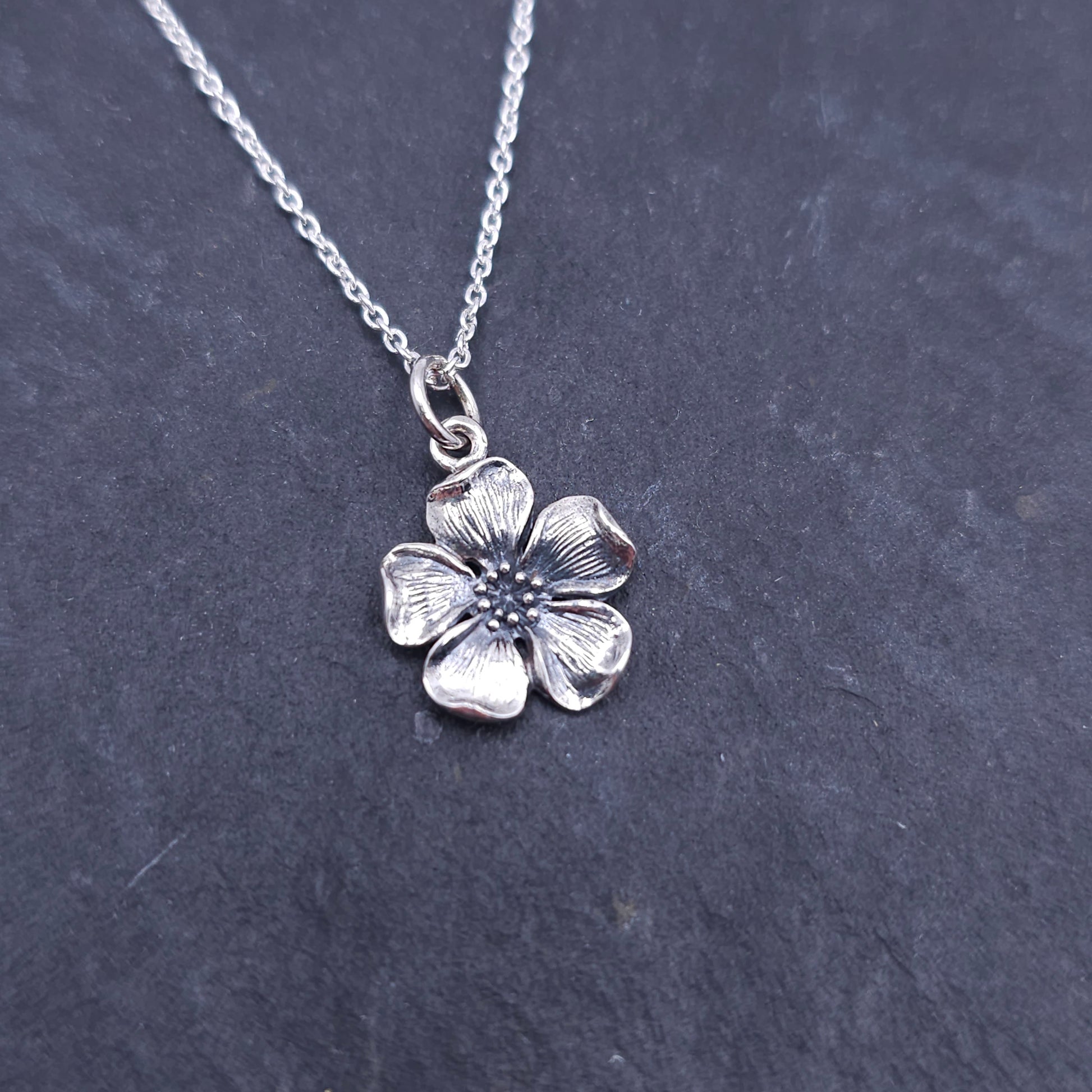 Silver oxidized flower necklace with 5 petals and scattered silver balls in center