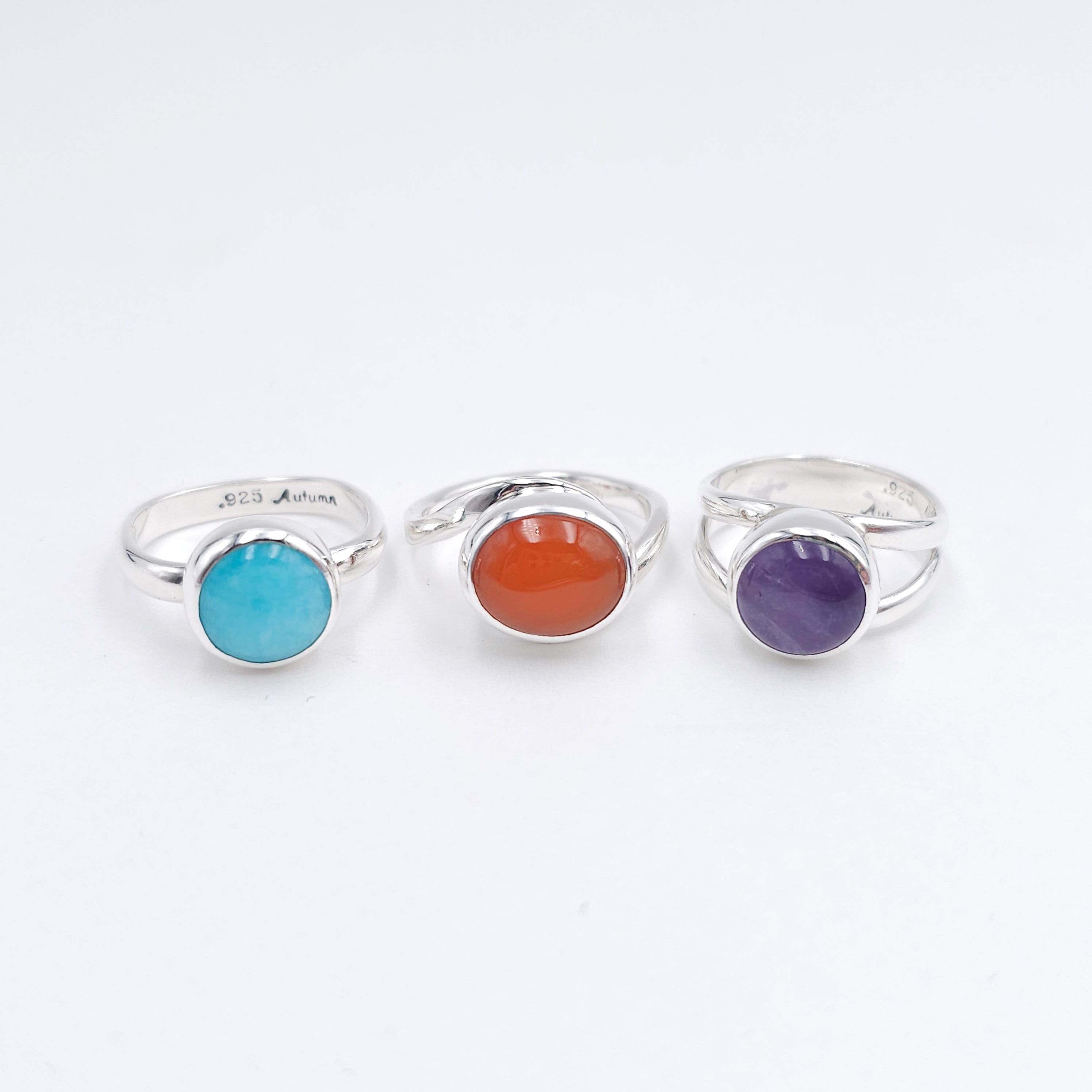 Sterling silver wave ring displayed on shell