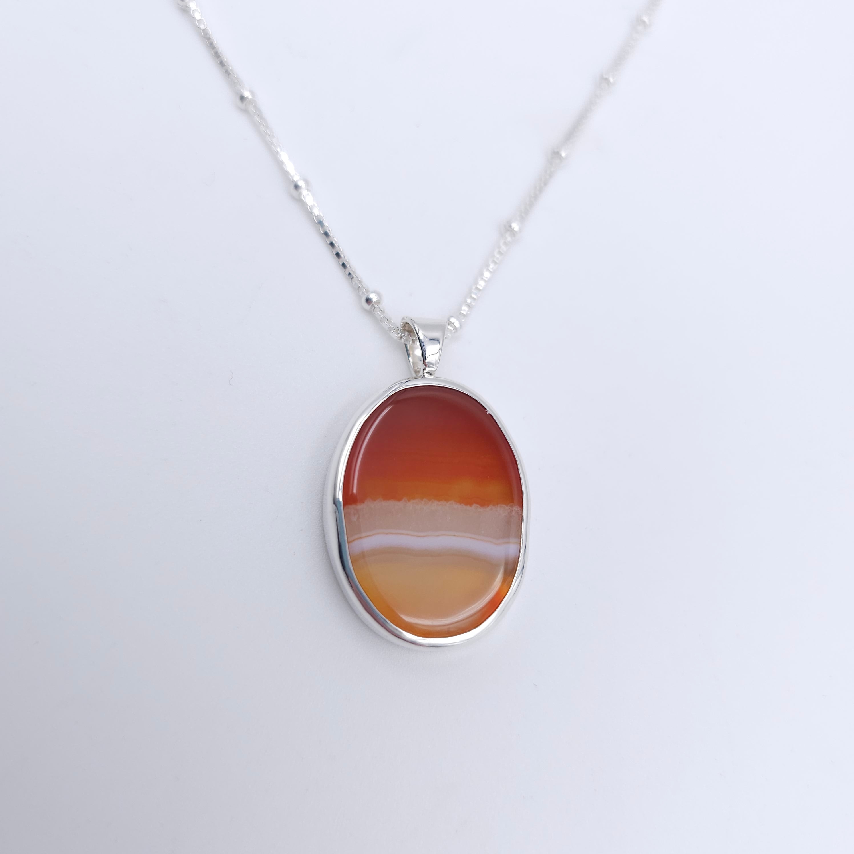 Silver bezel set necklace with orange banded agate 