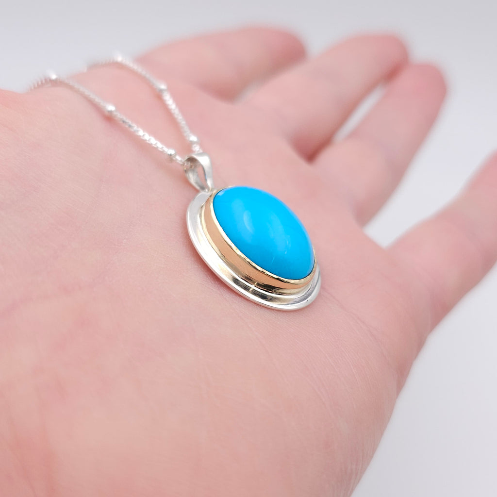 Turquoise oval bezel set necklace in sterling silver and 18k yellow gold
