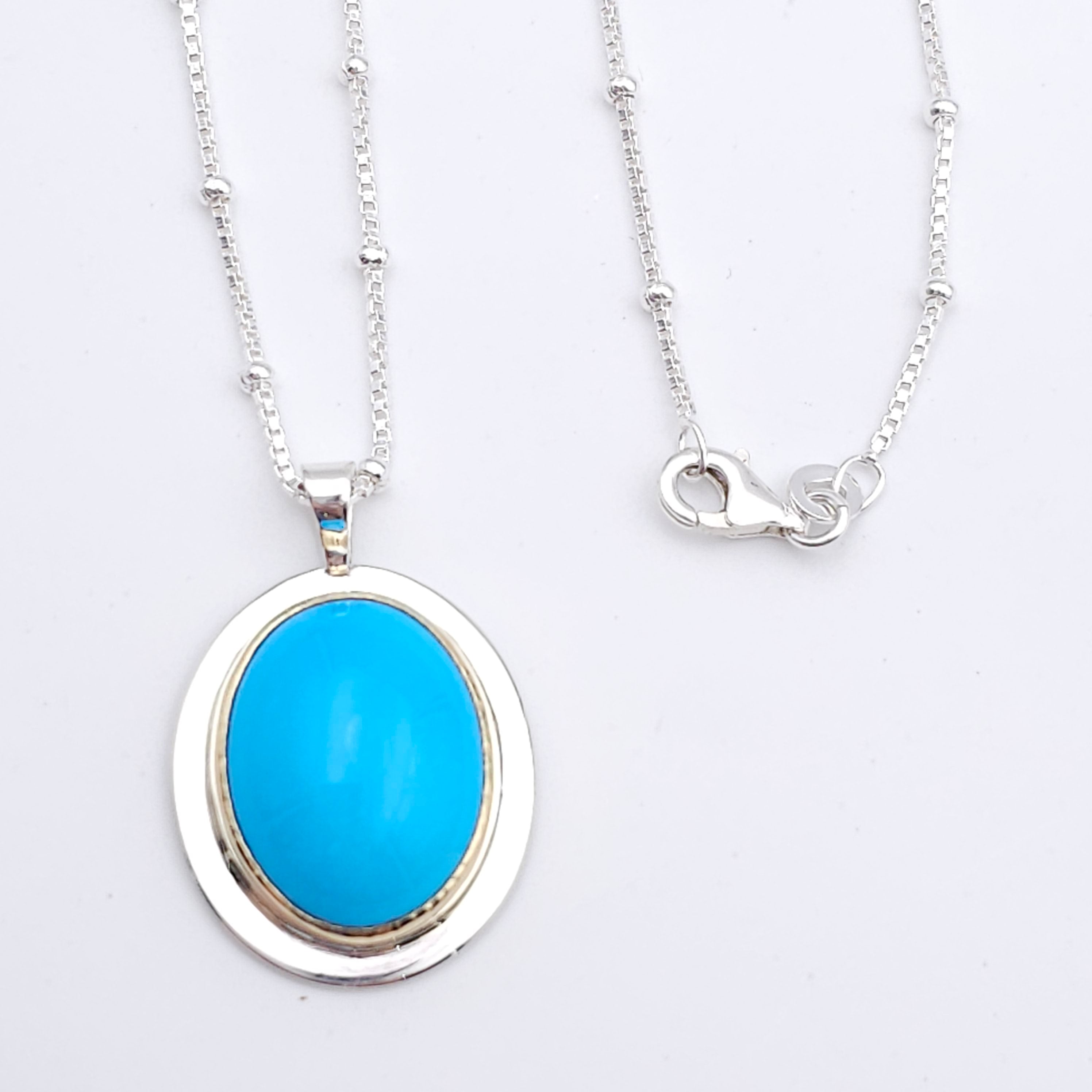 Turquoise oval bezel set necklace in sterling silver and 18k yellow gold