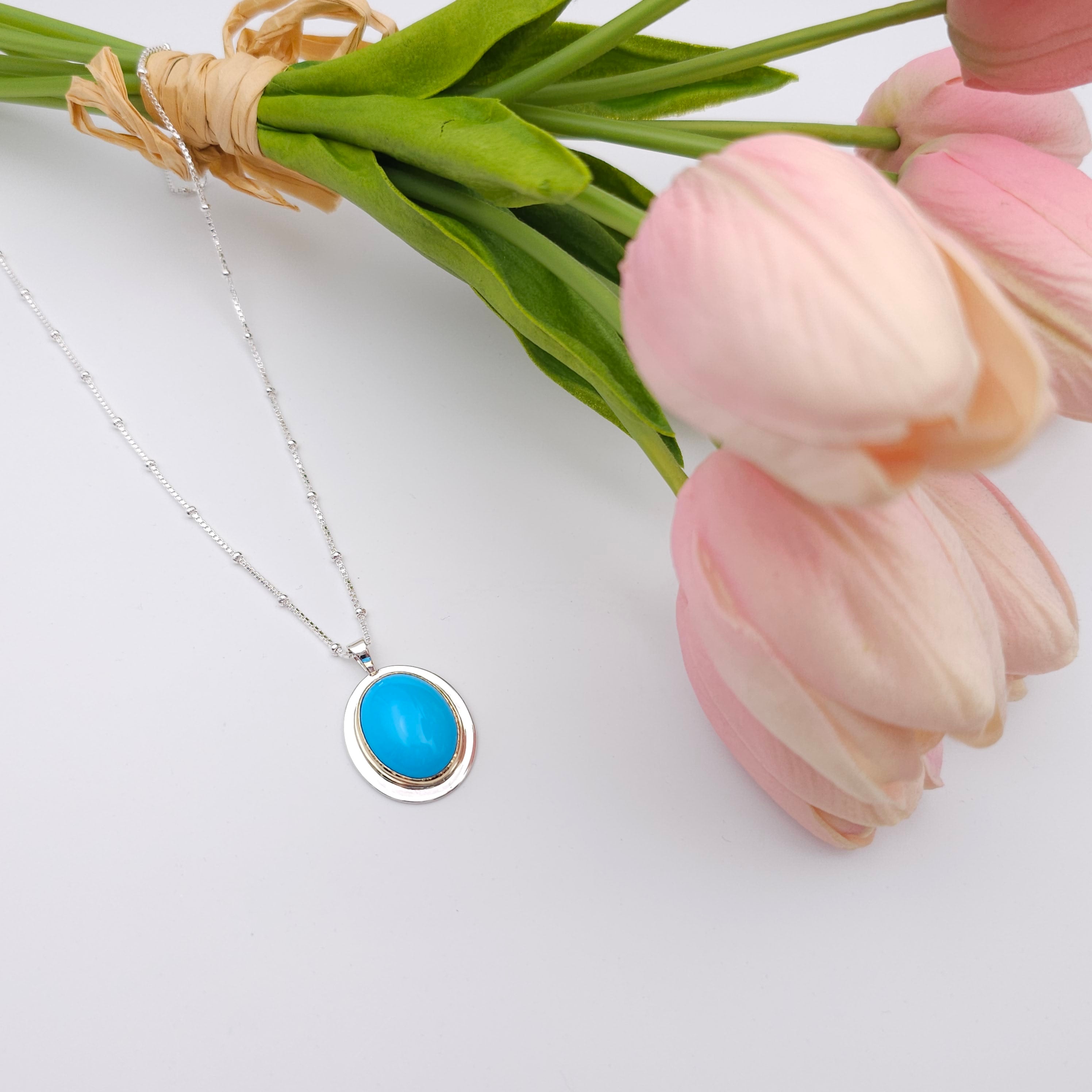 Turquoise oval bezel set necklace in sterling silver and 18k yellow gold