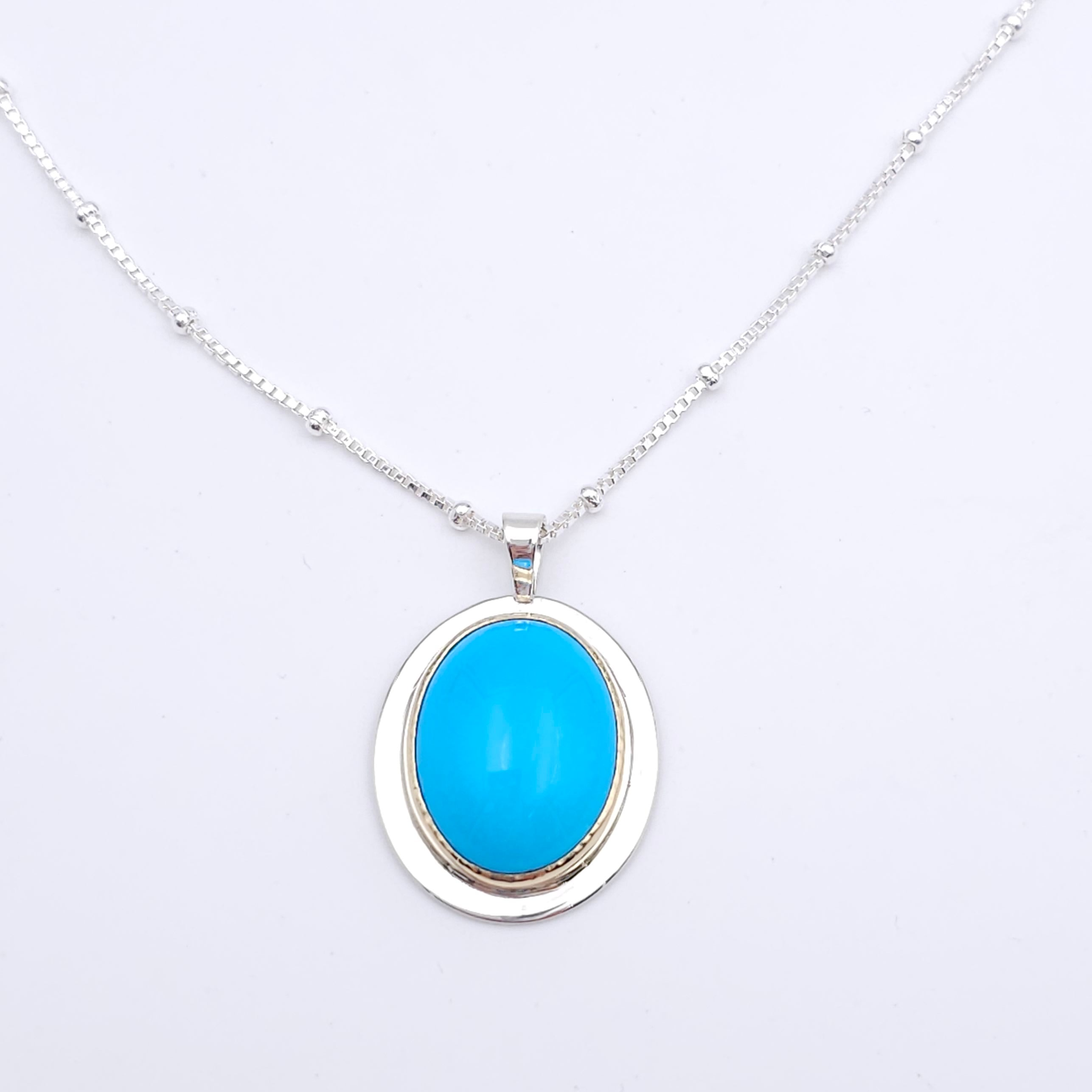 Turquoise oval bezel set necklace in sterling silver and 18k yellow gold