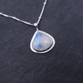Silver necklace with a teardrop-shaped rainbow moonstone pendant