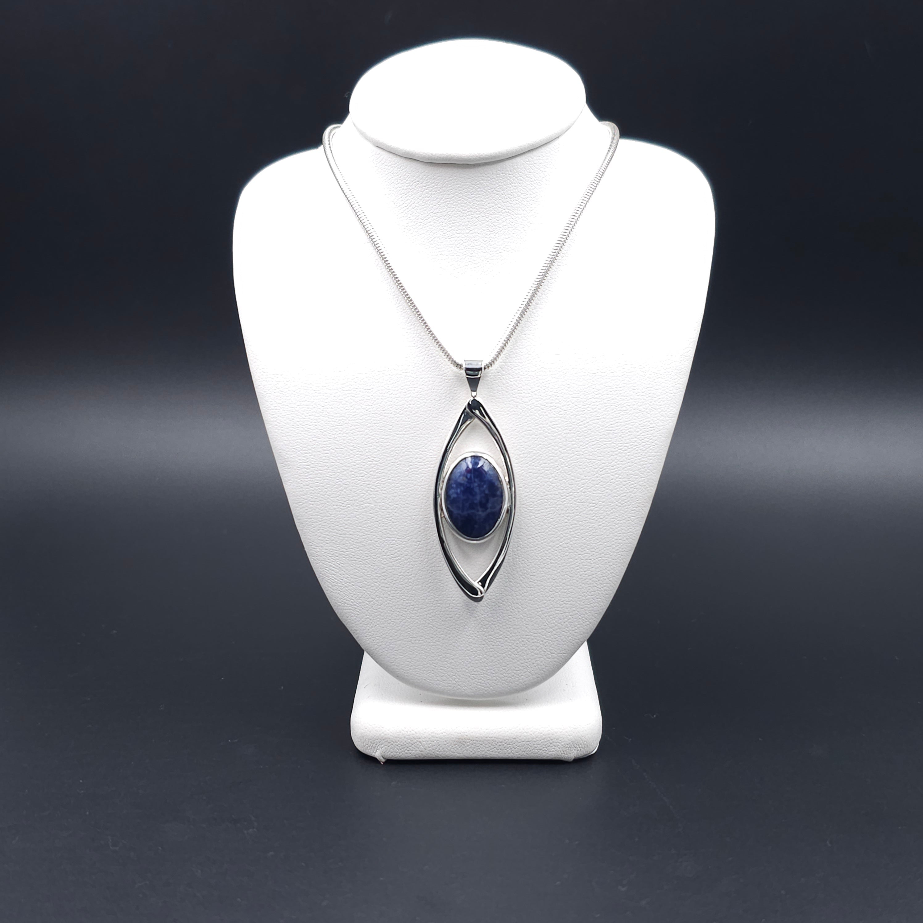 Marquis shaped open silver pendant with bezel set blue sodalite gem inside