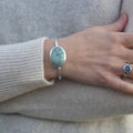 Light green bezel set silver cuff bracelet