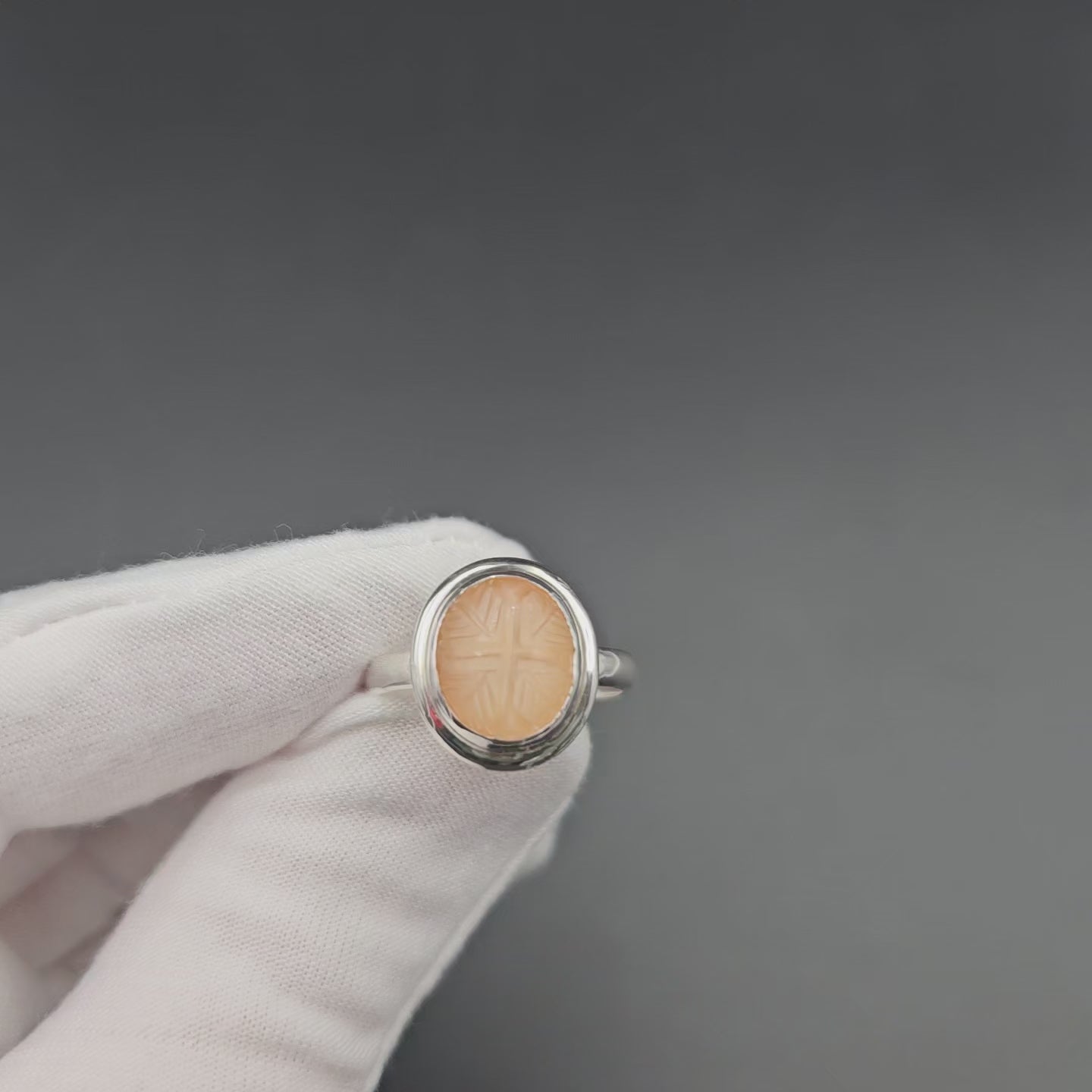 Carved peach moonstone sterling silver ring