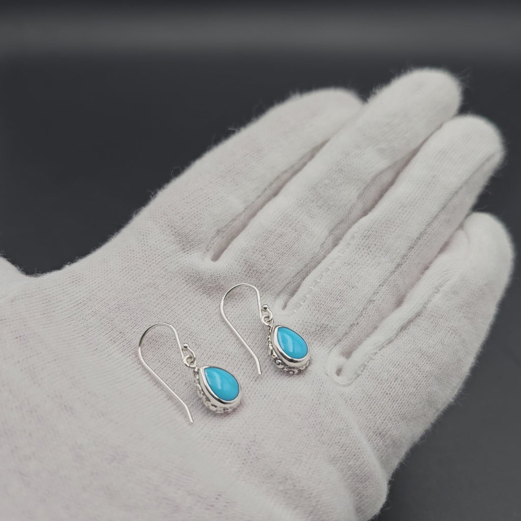 Turquoise teardrop sterling silver dangle earrings with floral border
