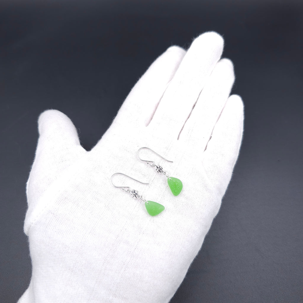 Green sea glass dangle earrings with flower accents in sterling silver