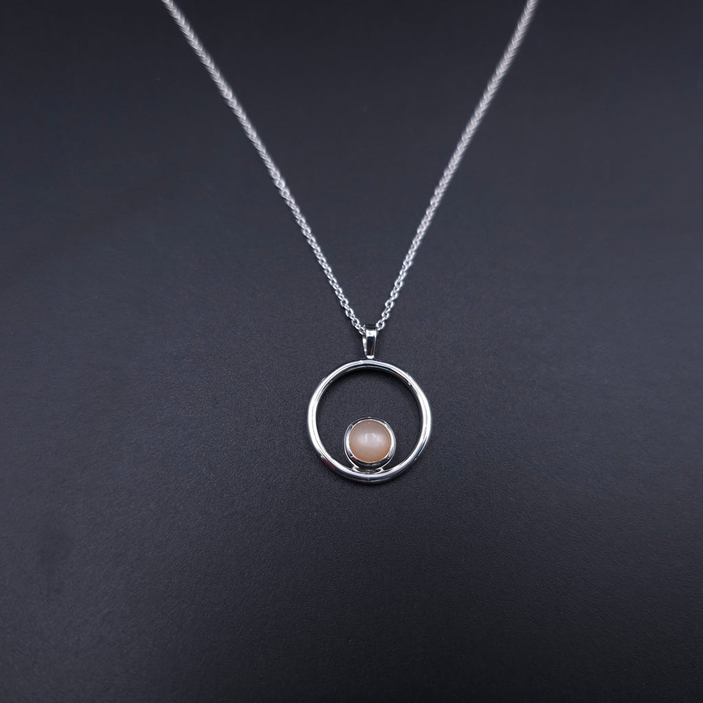 Silver circle necklace with peach moonstone