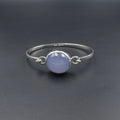 Silver hook on bracelet with light purple oval bezel set Chalcedony gemstone in center