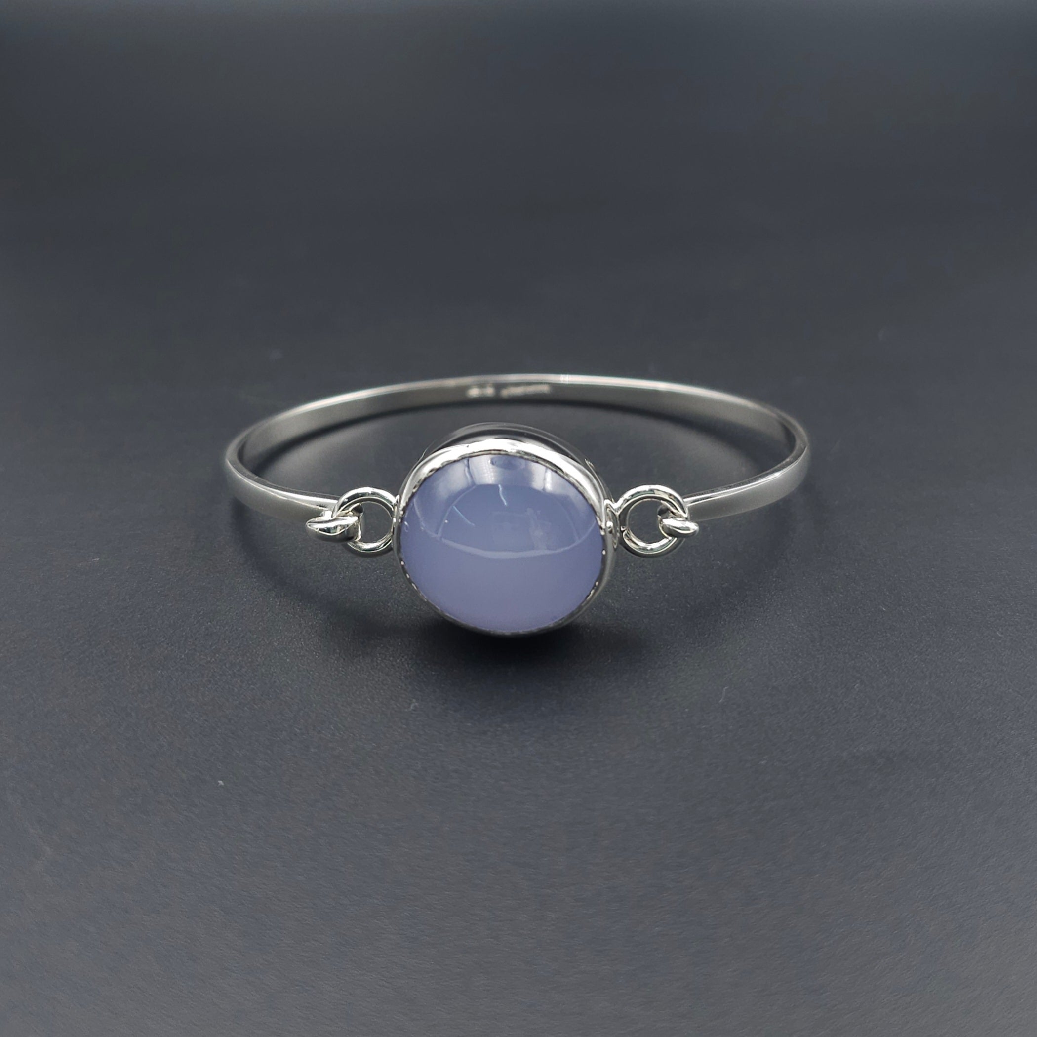 Silver hook on bracelet with light purple oval bezel set Chalcedony gemstone in center