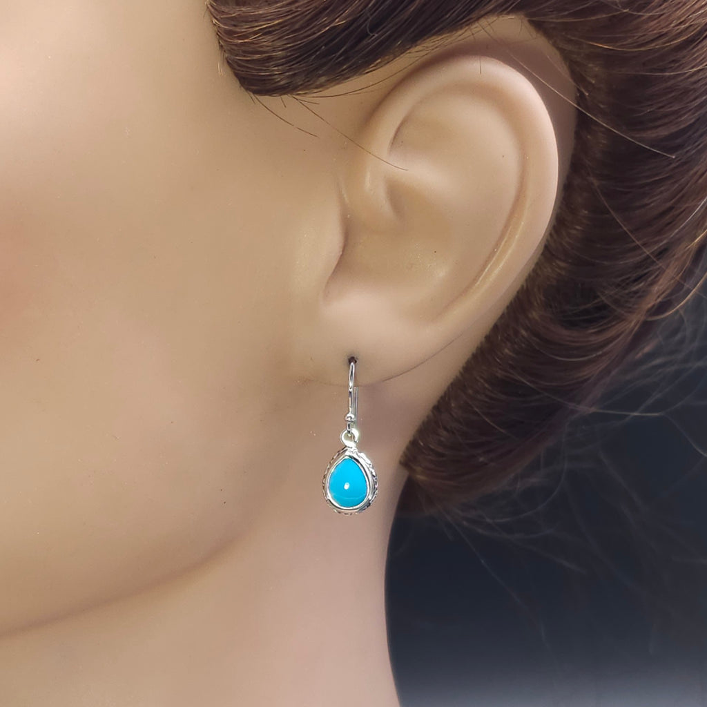 Turquoise teardrop sterling silver dangle earrings with floral border