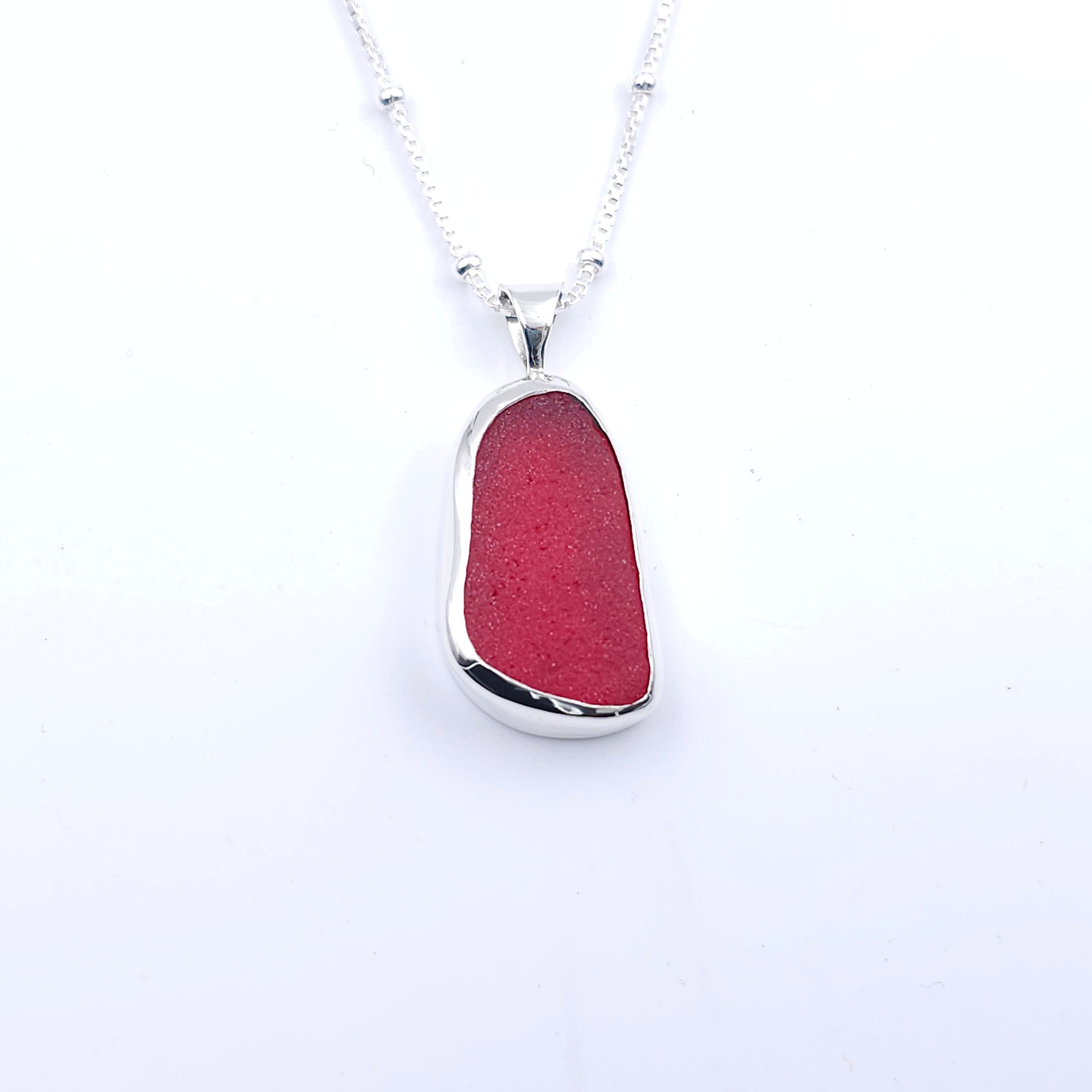 Red sea glass elongated shaped bezel set silver necklace