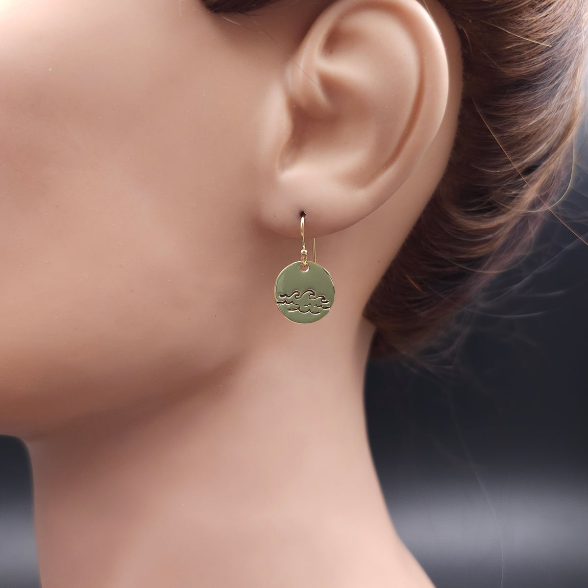 Round disc dangle earrings with blackened waves pattern.