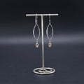 Sterling silver marquise shaped earrings with peach moonstone dangles