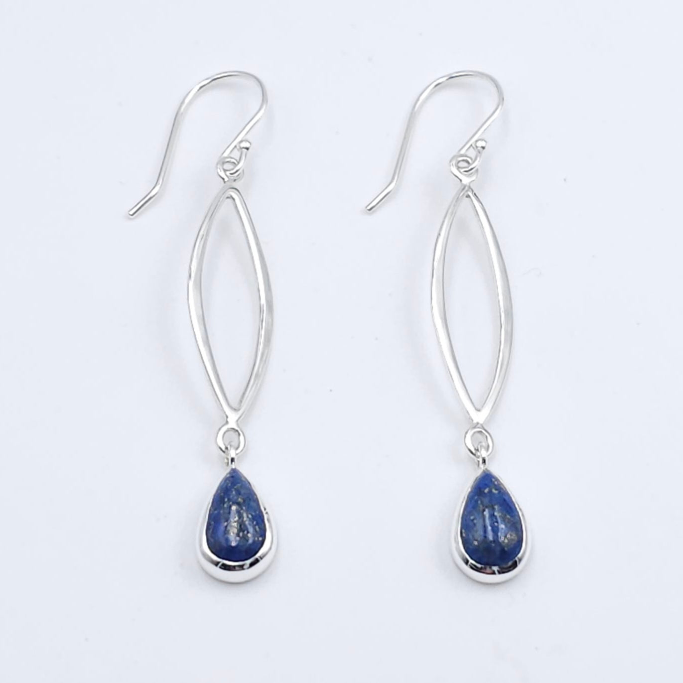 Silver wire in marquis shape dangles below french earring wires, with bezel set lapis stones dangling below marquis.