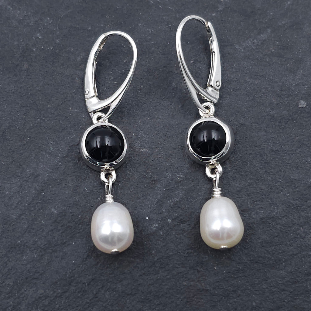 Round bezel set black onyx earrings with teardrop fresh water pearls hanging from bezels