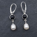Round bezel set black onyx earrings with teardrop fresh water pearls hanging from bezels
