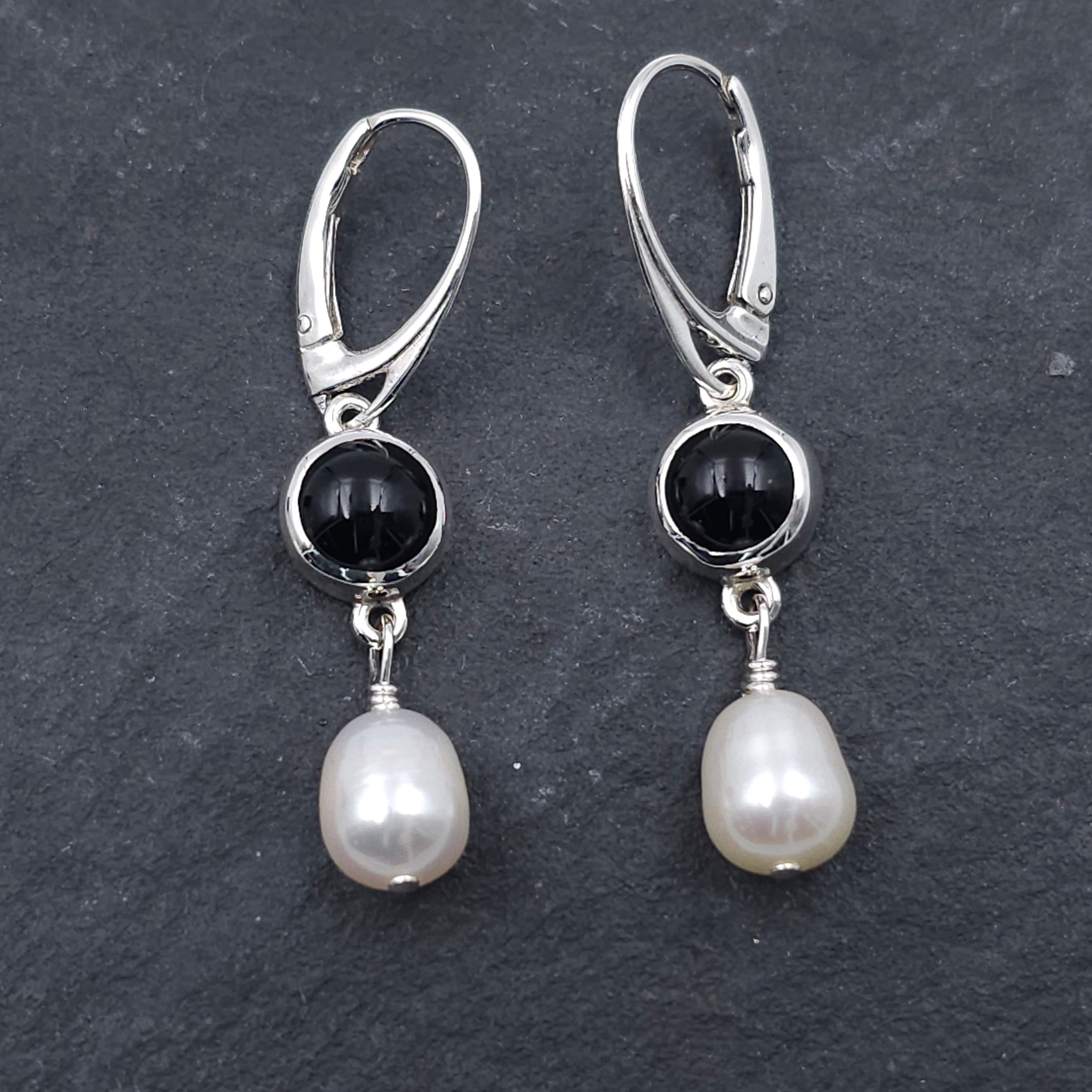 Round bezel set black onyx earrings with teardrop fresh water pearls hanging from bezels