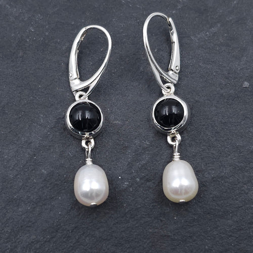 Round bezel set black onyx earrings with teardrop fresh water pearls hanging from bezels