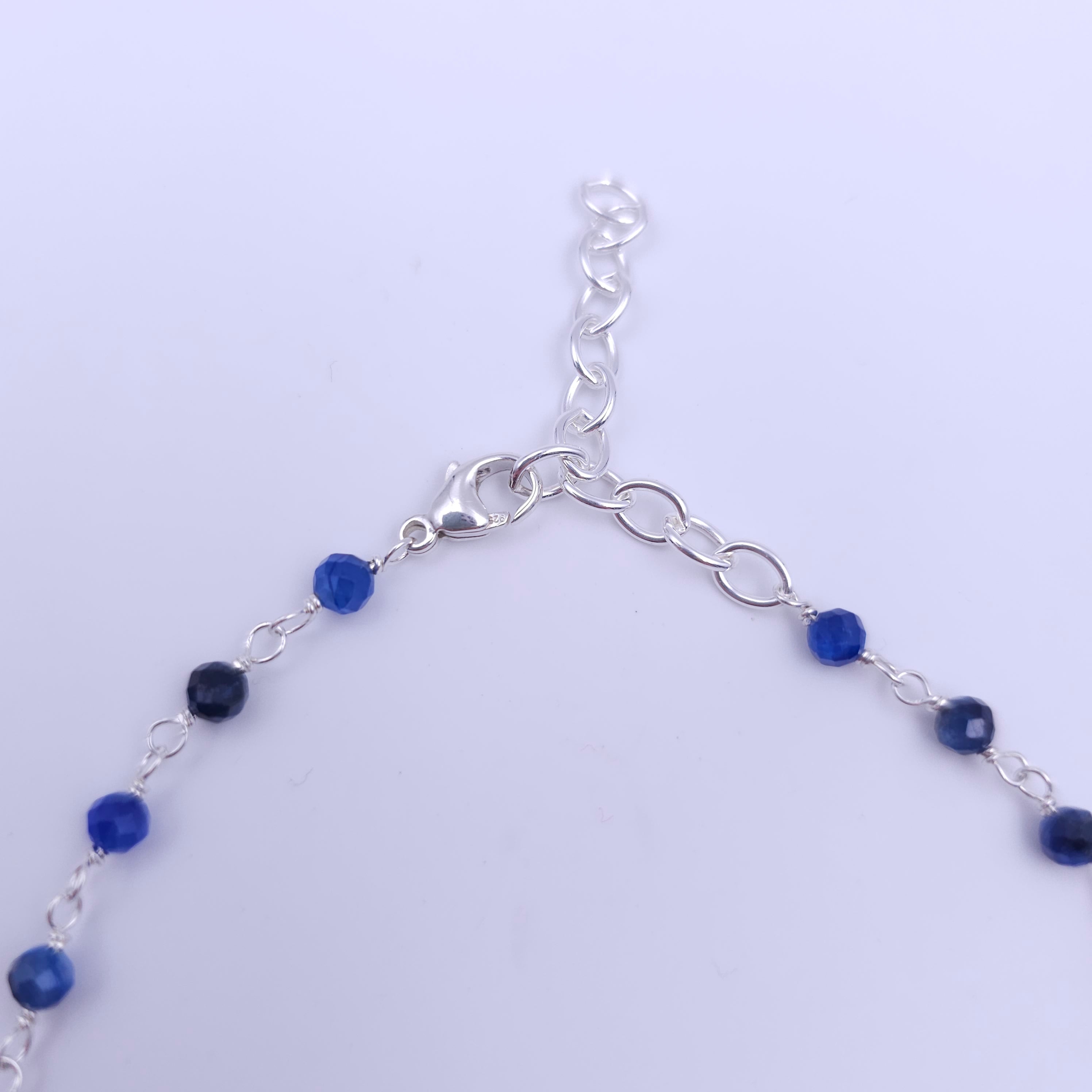 Shows silver lobster clasp with 2" of oval silver chain for adjustability