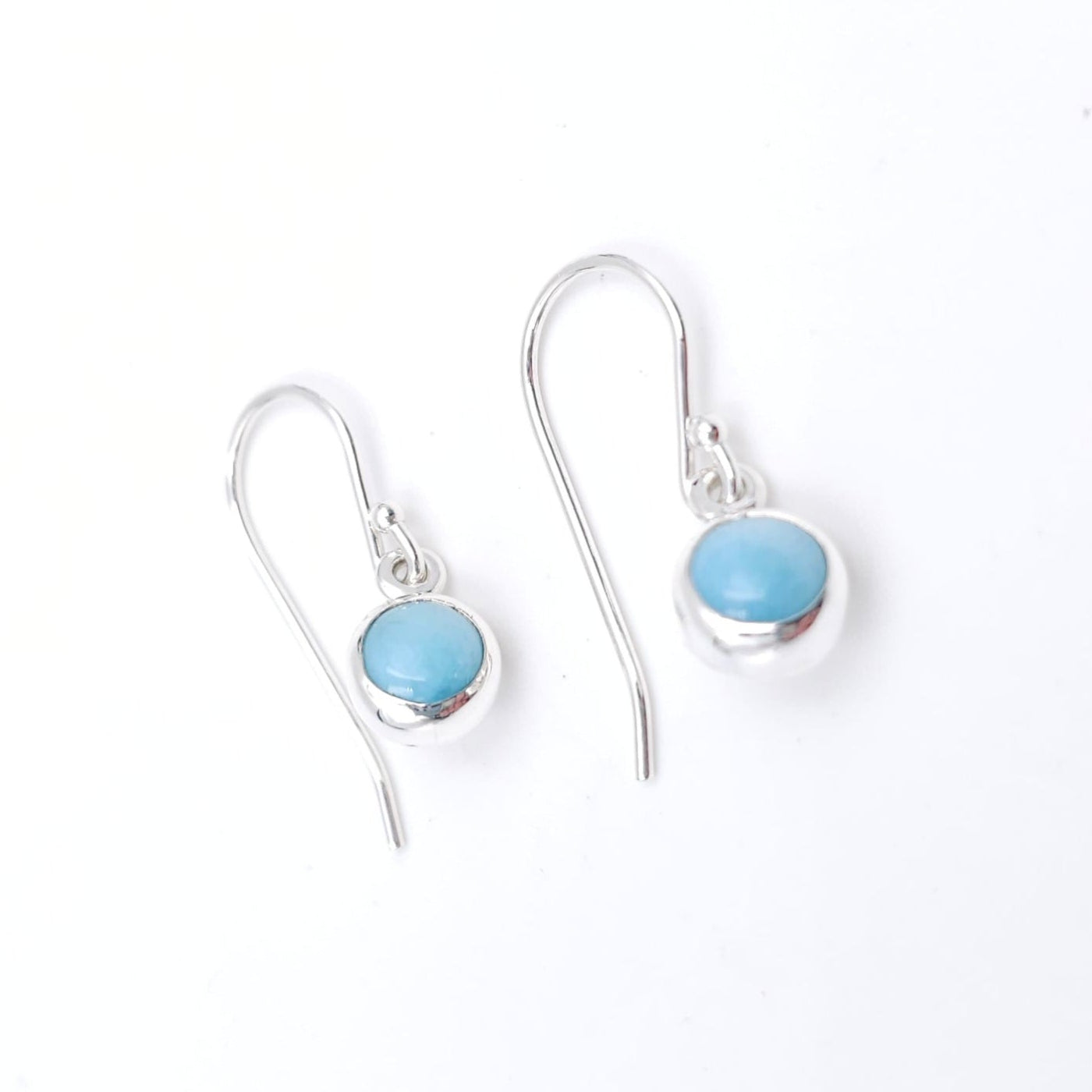 Silver bezel set light blue larimar dangle earrings. 