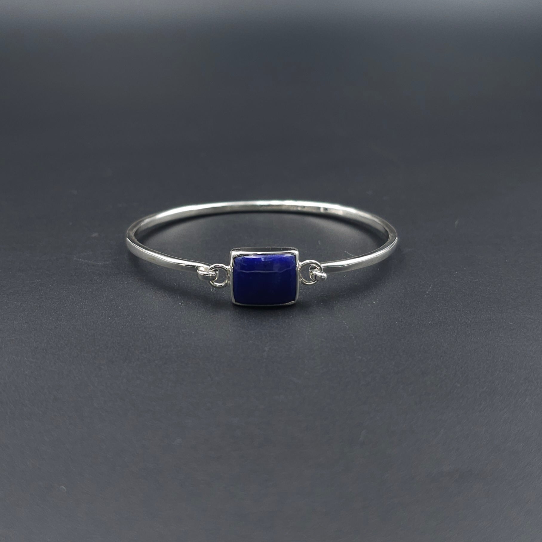 Oval silver hook on bracelet with rectangle blue lapis lazuli stone bezel set in center