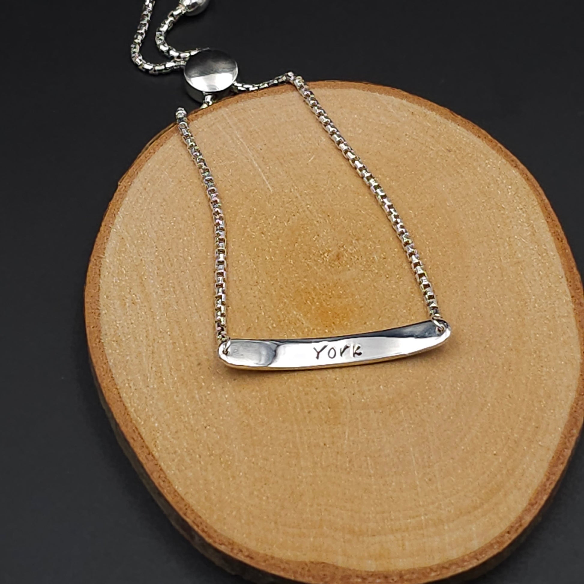 The inside of the bar bracelet with the work York Stamped on it