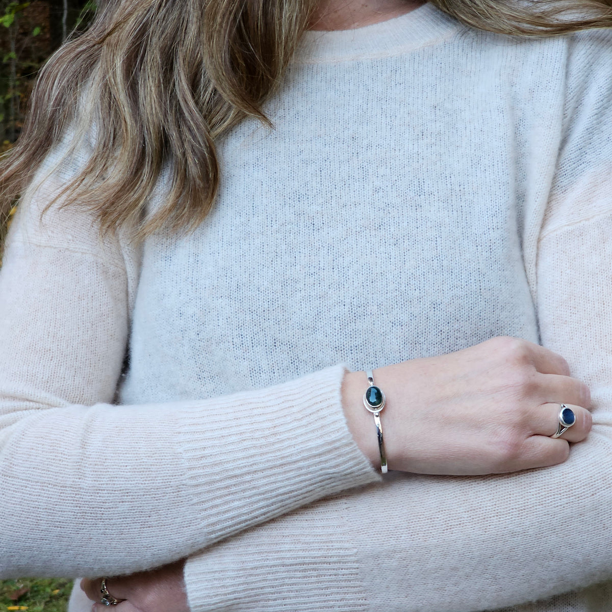 Oval bezel set moss agate with textured border sterling silver cuff bracelet