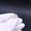 Silver ring with a domed circle with the outline of the state of Maine attached to the ring shank.