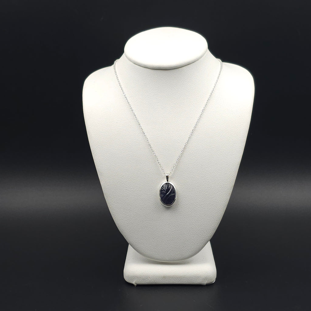 Carved iolite bezel set sterling silver necklace
