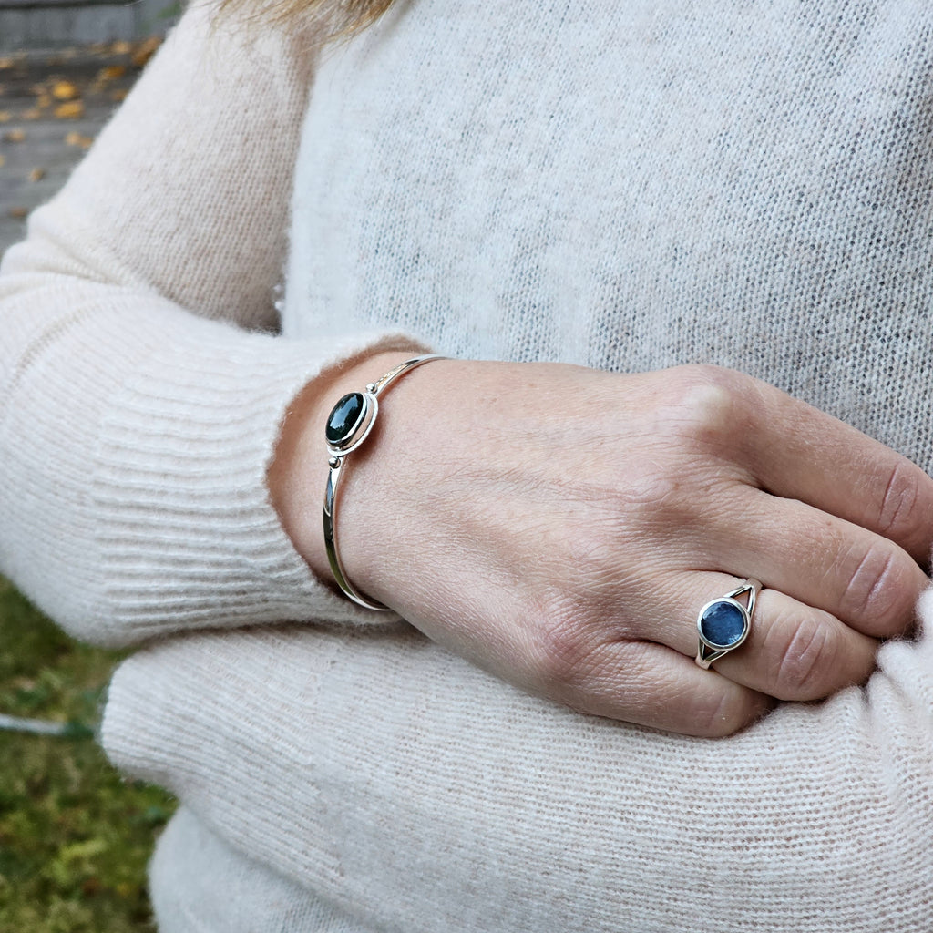 Oval bezel set moss agate with textured border sterling silver cuff bracelet