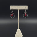 Open pointed teardrop shaped with red sea glass dangling inside earrings, hanging from French earring wires.