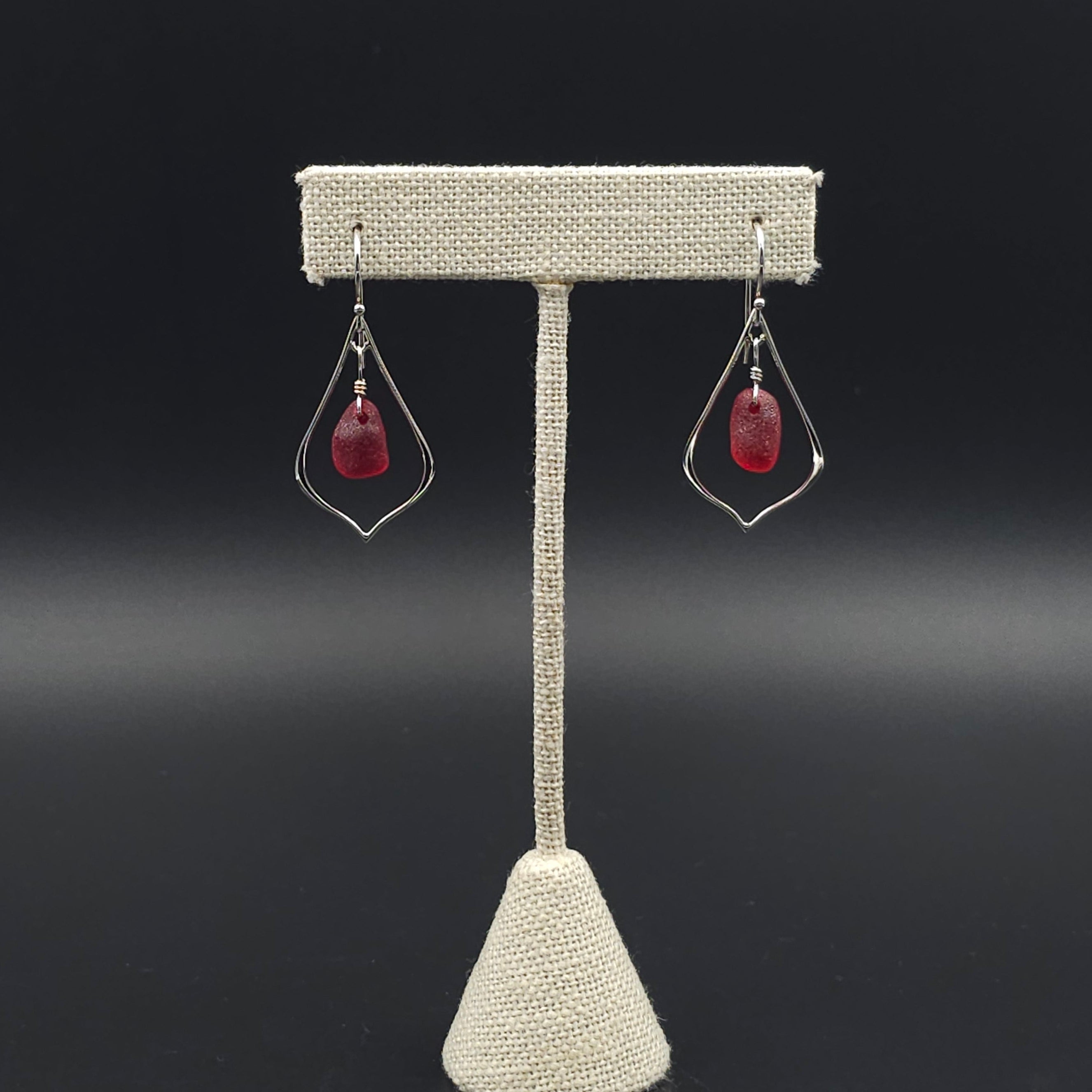Open pointed teardrop shaped with red sea glass dangling inside earrings, hanging from French earring wires.