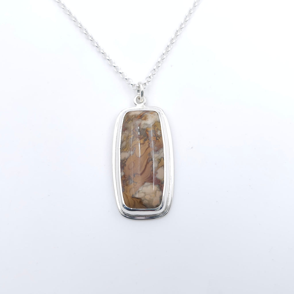 Rectangle bezel set Jasper pendant with swirling colors of brown, beige, and maroon in gemstone