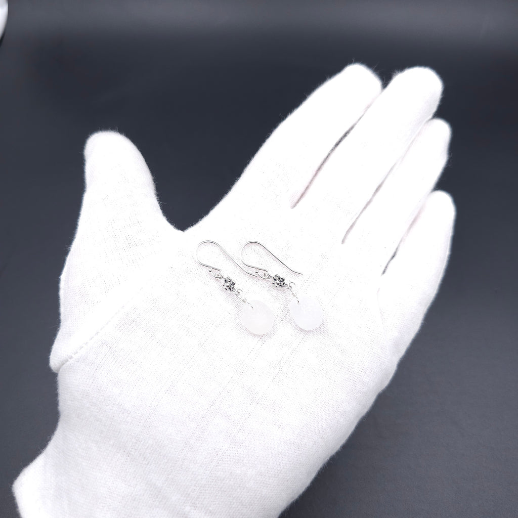 White sea glass dangle earrings with flower accents in sterling silver