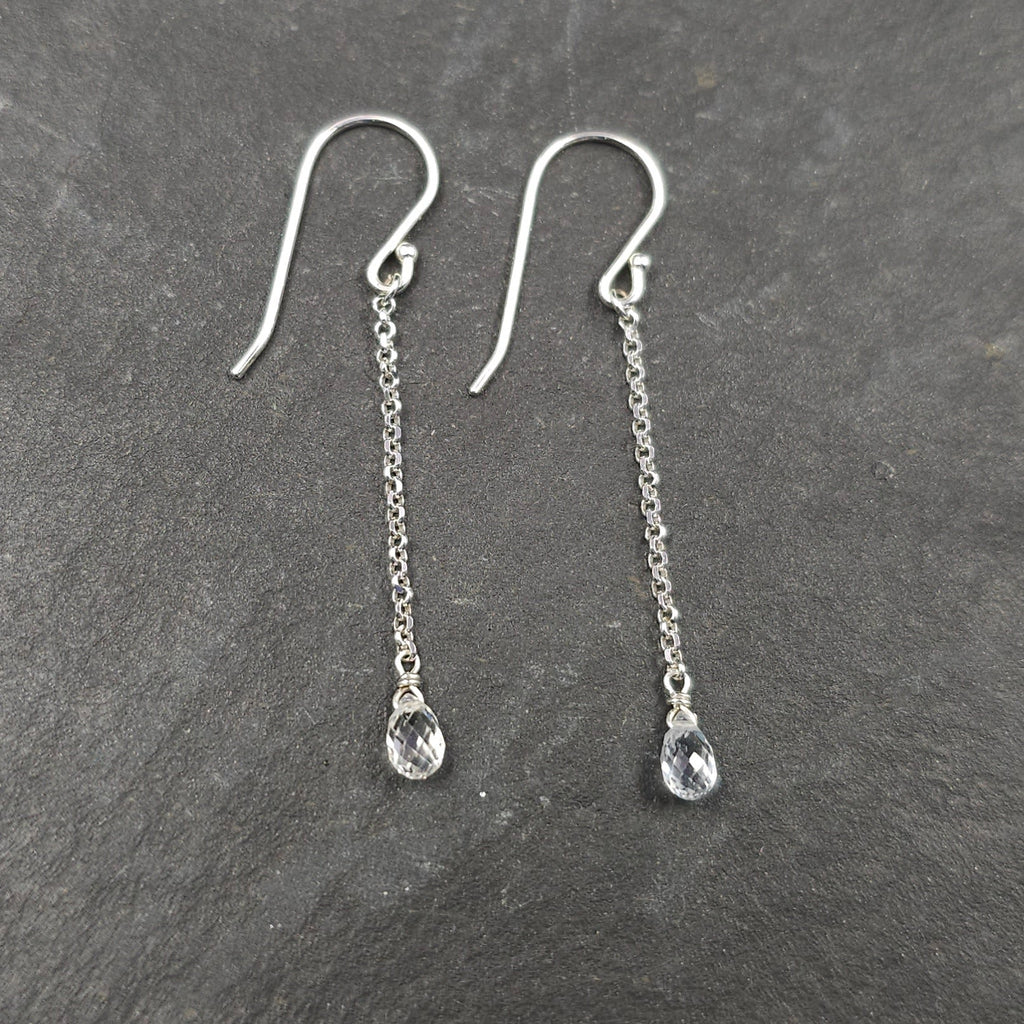 Teardrop clear white sapphire briolettes dangle from silver chain and French earring wires