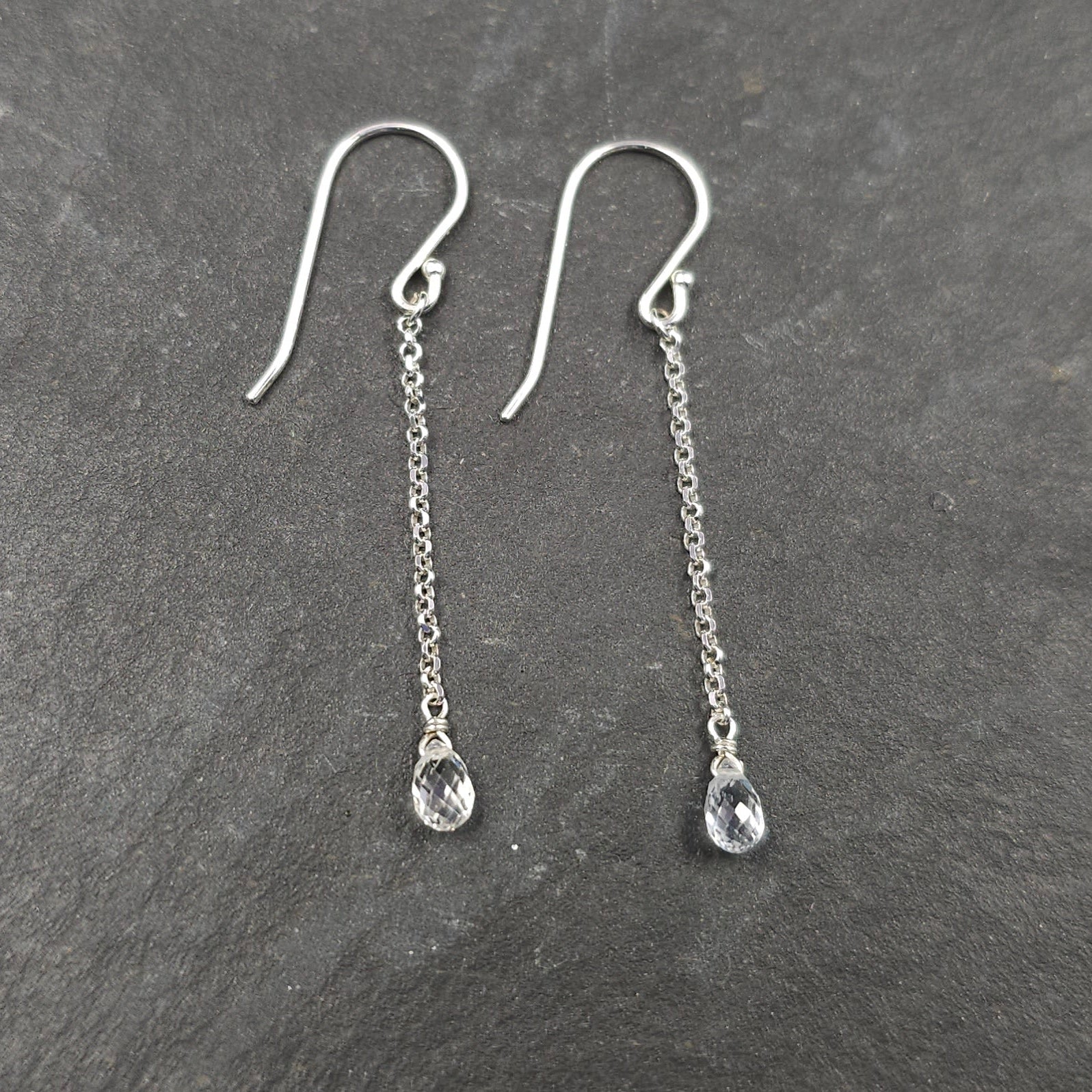 Teardrop clear white sapphire briolettes dangle from silver chain and French earring wires