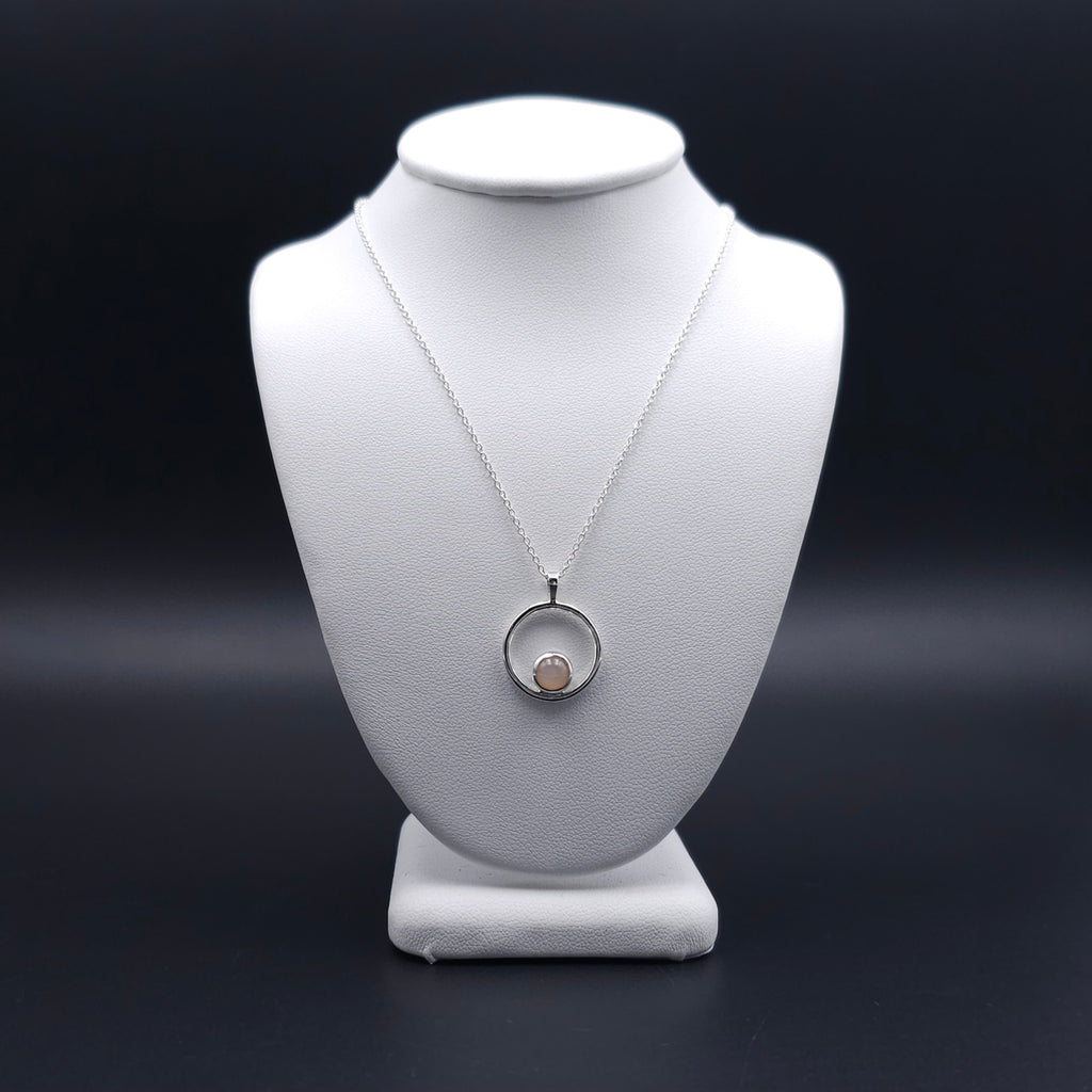 Silver circle necklace with peach moonstone