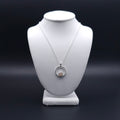 Silver circle necklace with peach moonstone