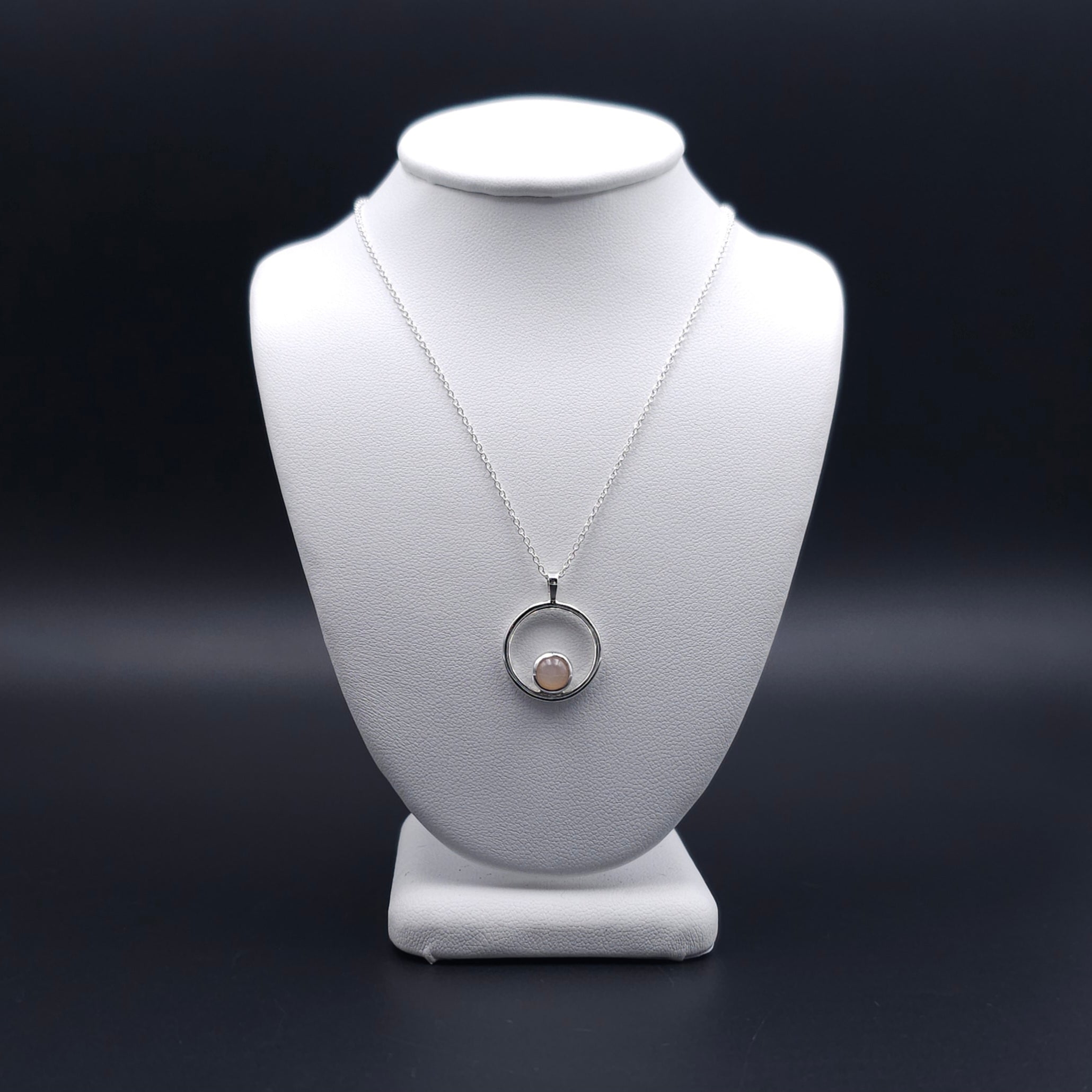 Silver circle necklace with peach moonstone