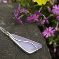 Lavender colored Yttrium flourite stone bezel set necklace with silver wire on the top in a curved design
