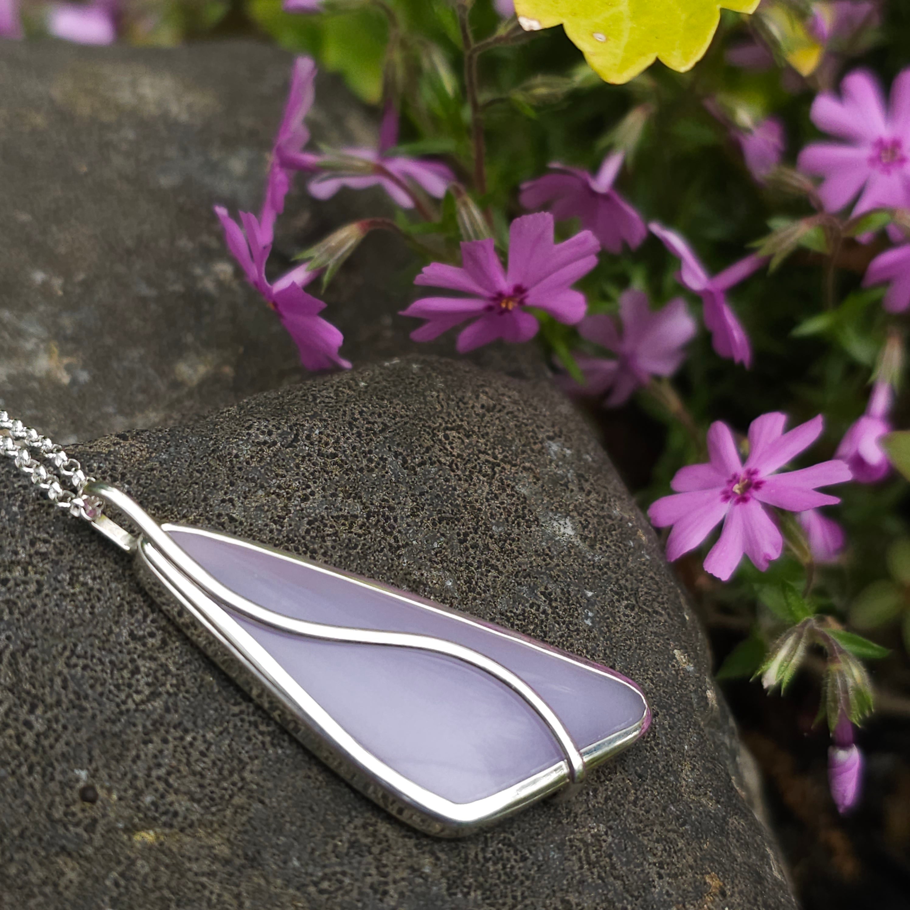 Lavender colored Yttrium flourite stone bezel set necklace with silver wire on the top in a curved design