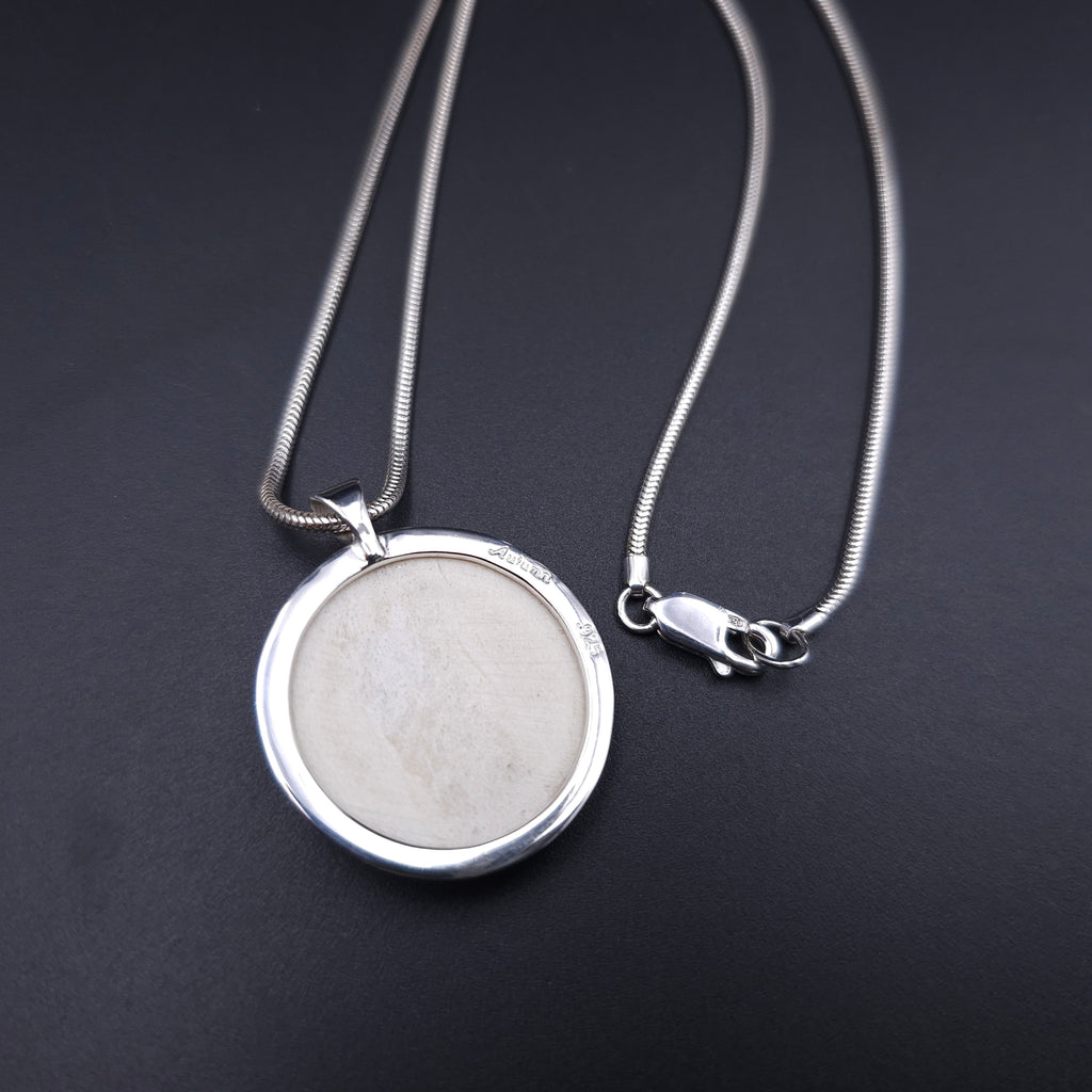 Carved face sterling silver necklace