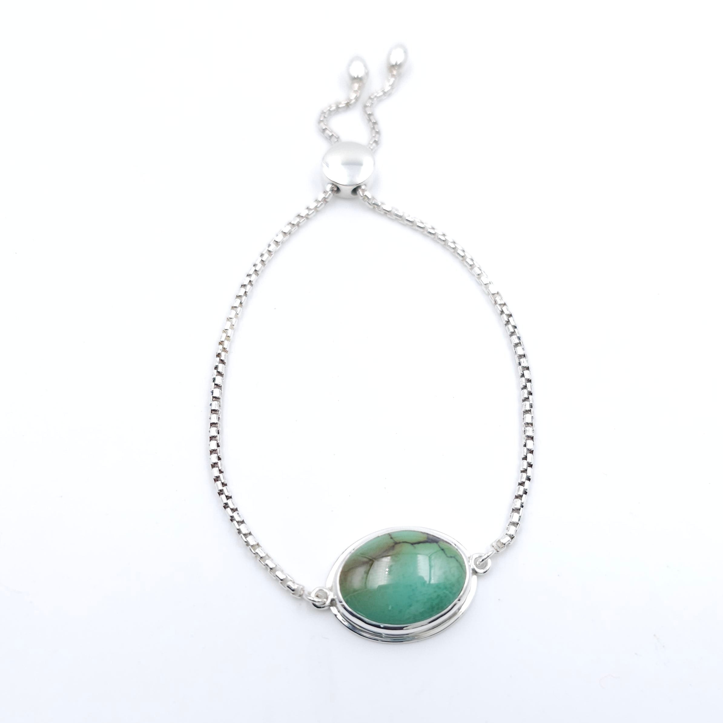 Adjustable silver chain bracelet with bezel set green turquoise with some brown veining