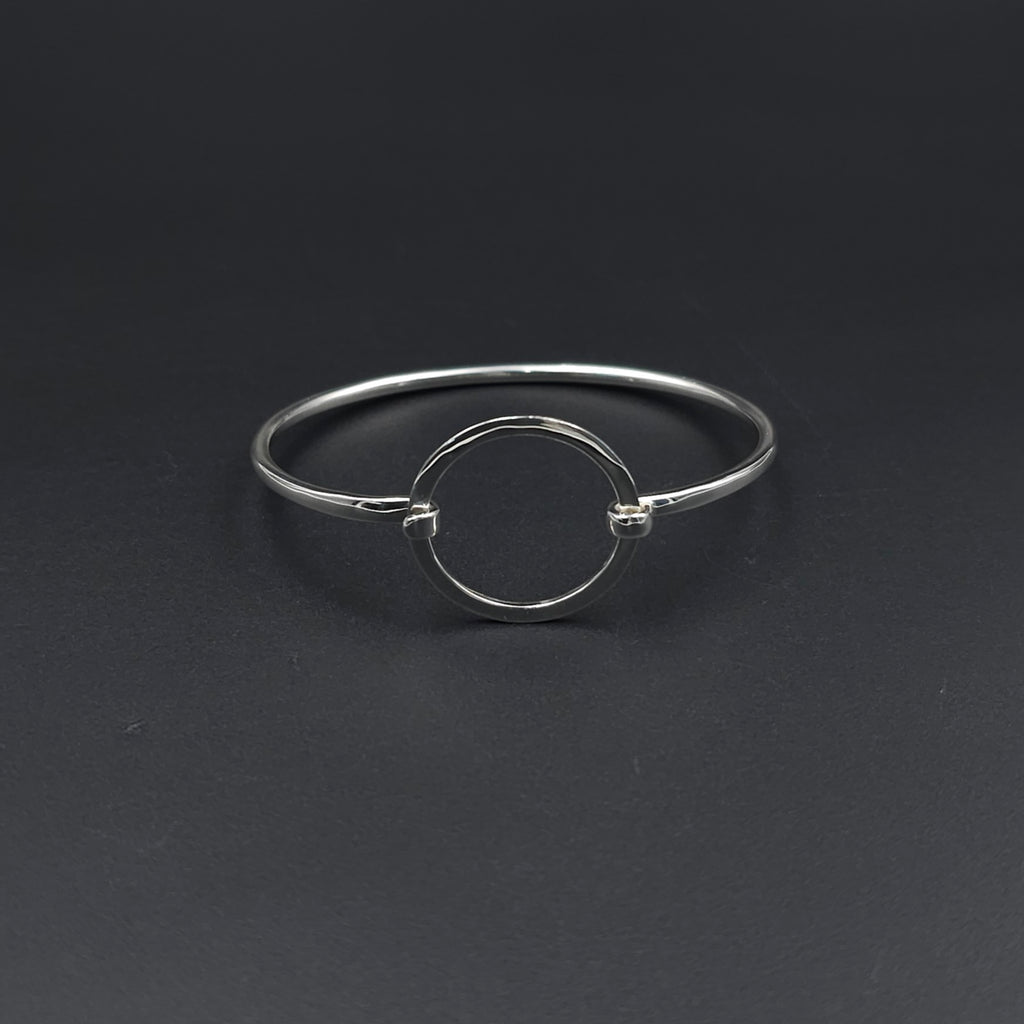 Hook on silver bracelet with slightly hammered open circle in center
