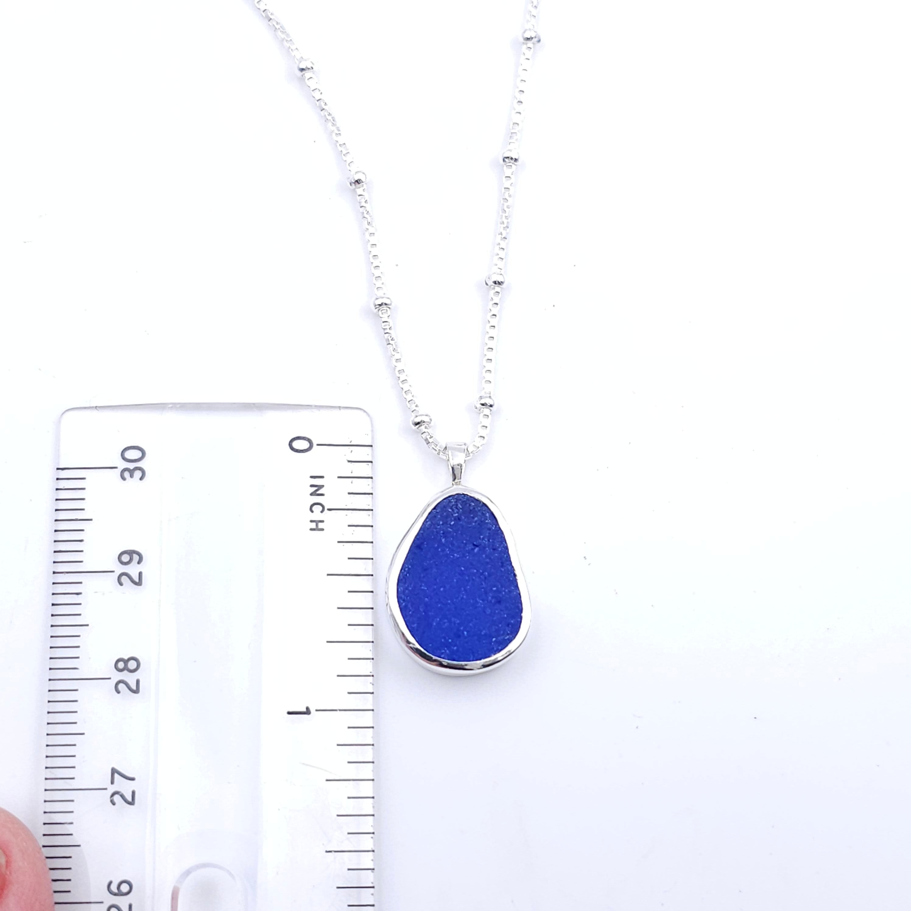 sea glass necklace with ruler showing 7/8" length