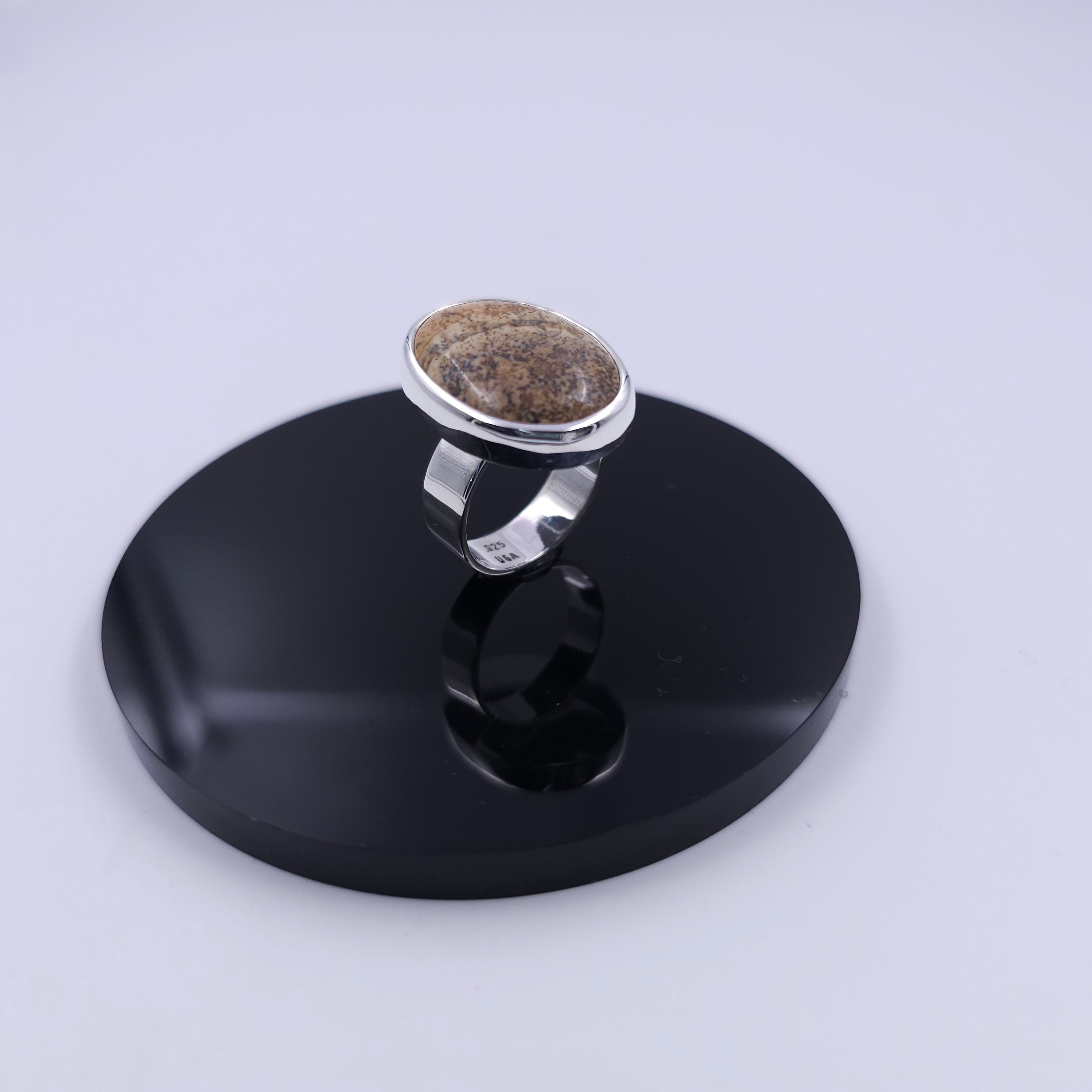 Large oval bezel set brown Jasper with blotches of different shades of brown and black spots