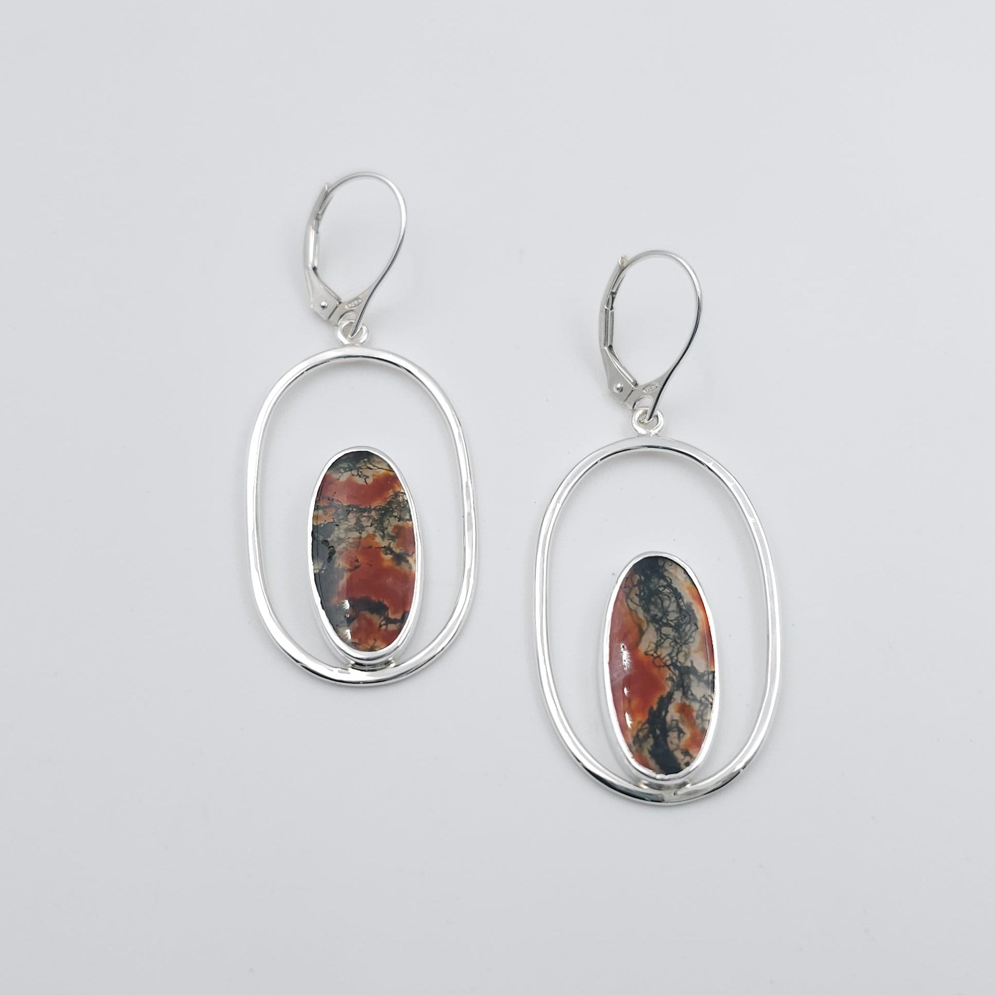 vertical oval silver wire frame earrings with bezel set long oval moss agate gemstones on lever back earring wires